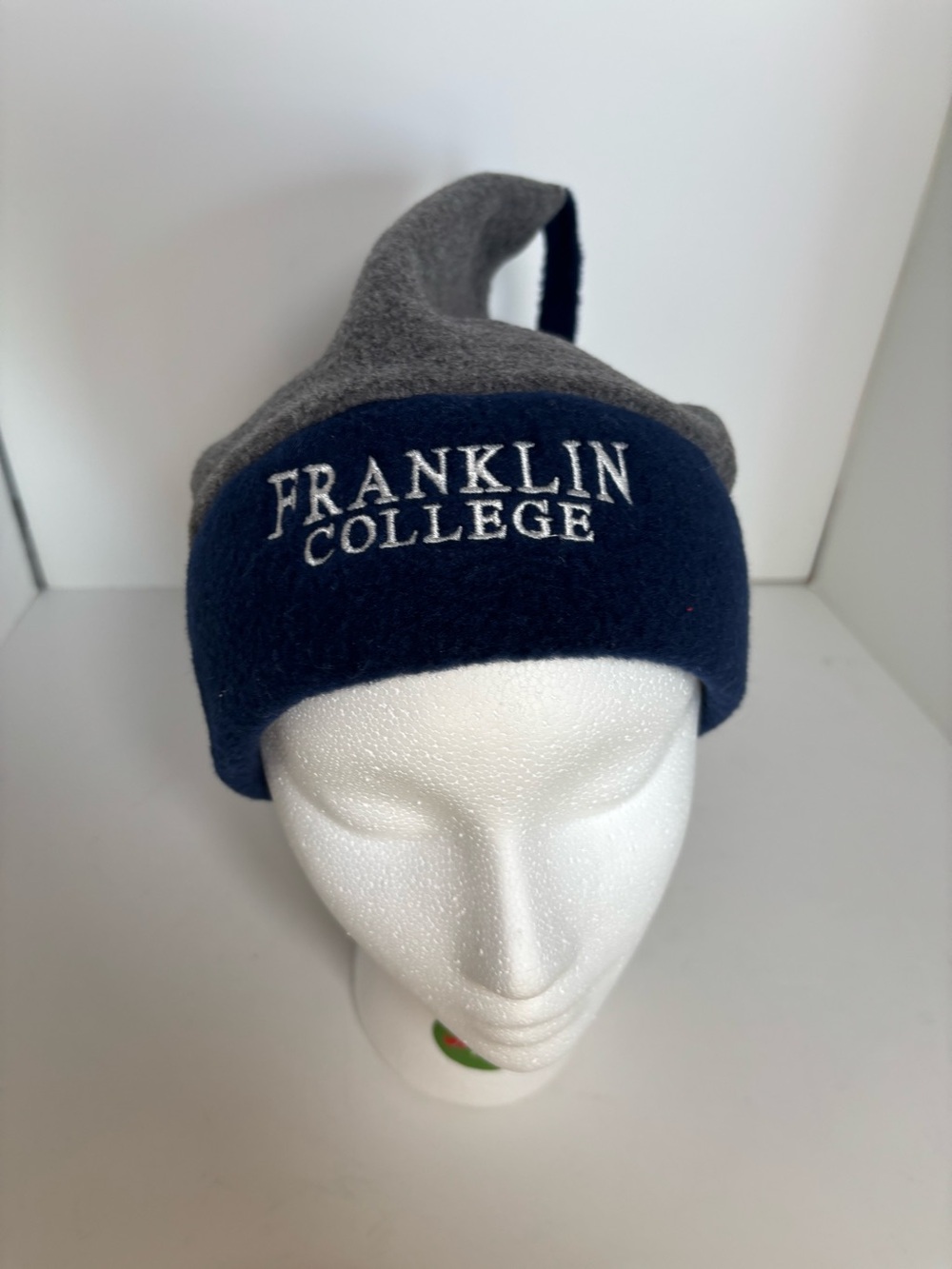 Franklin College gray and navy blue winter beanie hat with embroidered logo